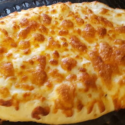 Cheesy breadstick close-up on the rack