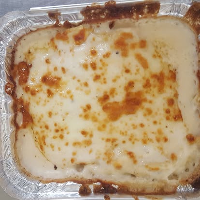 Cheesy baked pasta in a foil pan
