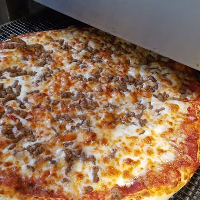 Sausage pizza coming out of the oven