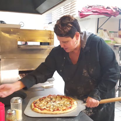 Pizza fresh from the oven — action shot