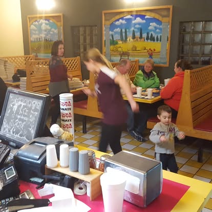 Busy dining room with Italian murals