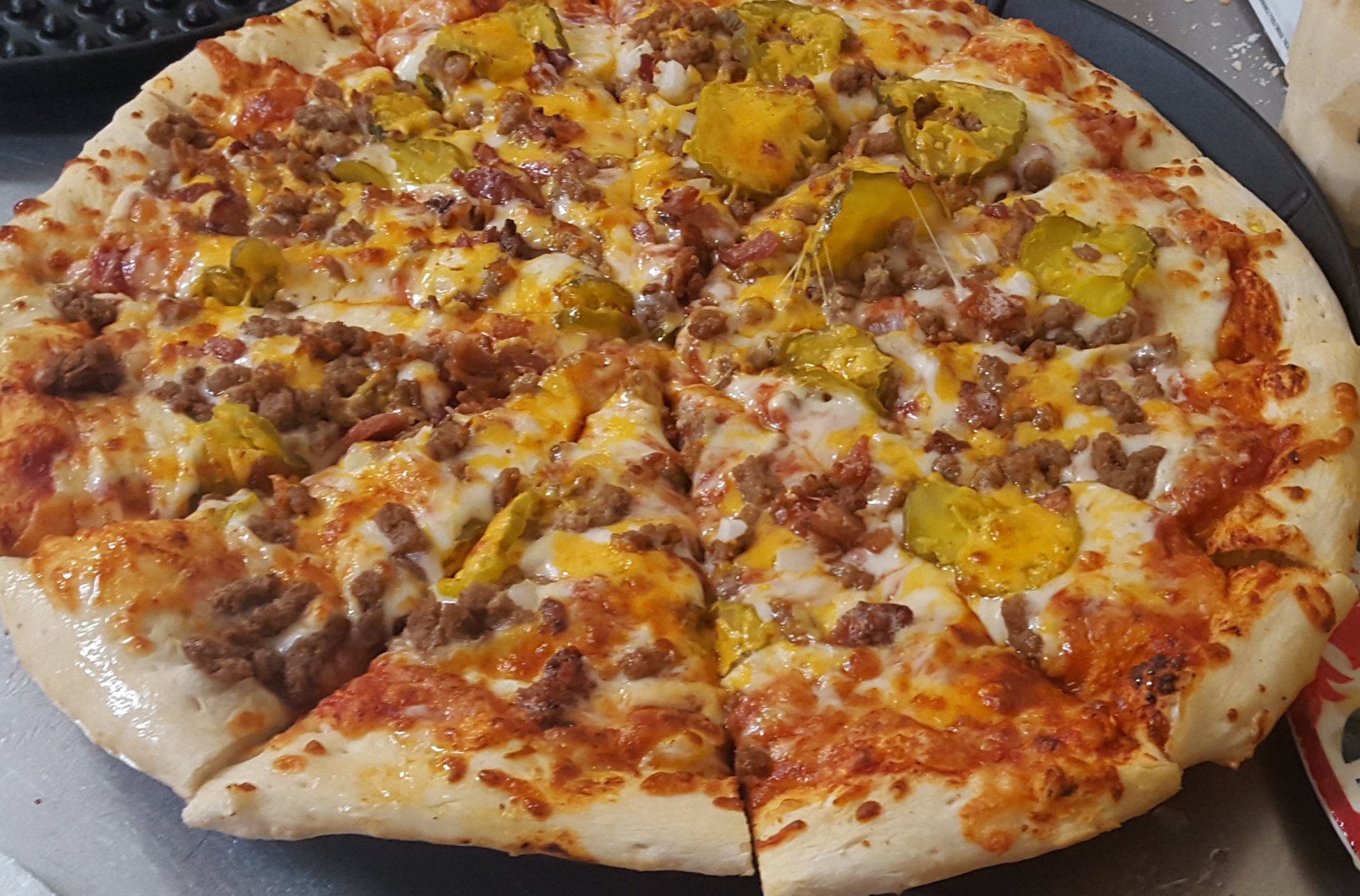 Cheeseburger pizza with pickles and cheddar
