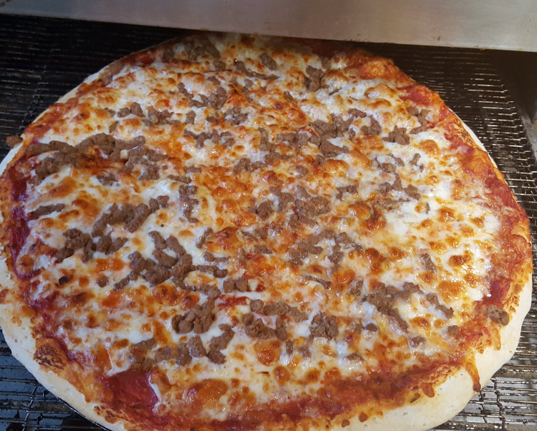 Sausage pizza on the oven rack